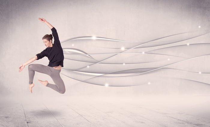 Ballet dancer performing modern dance with abstract lines concept on background